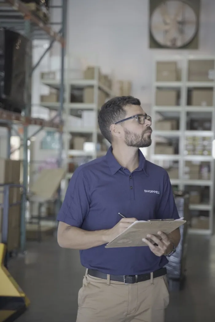 Shoppex team member checking inventory in our Doral warehouse